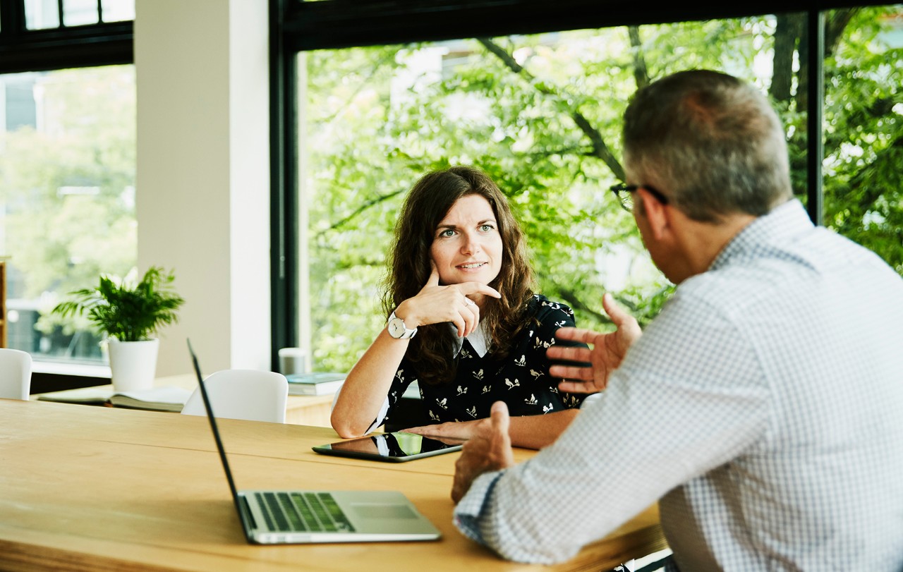 Woman man talking Business colleagues having planning meeting in small office conference room