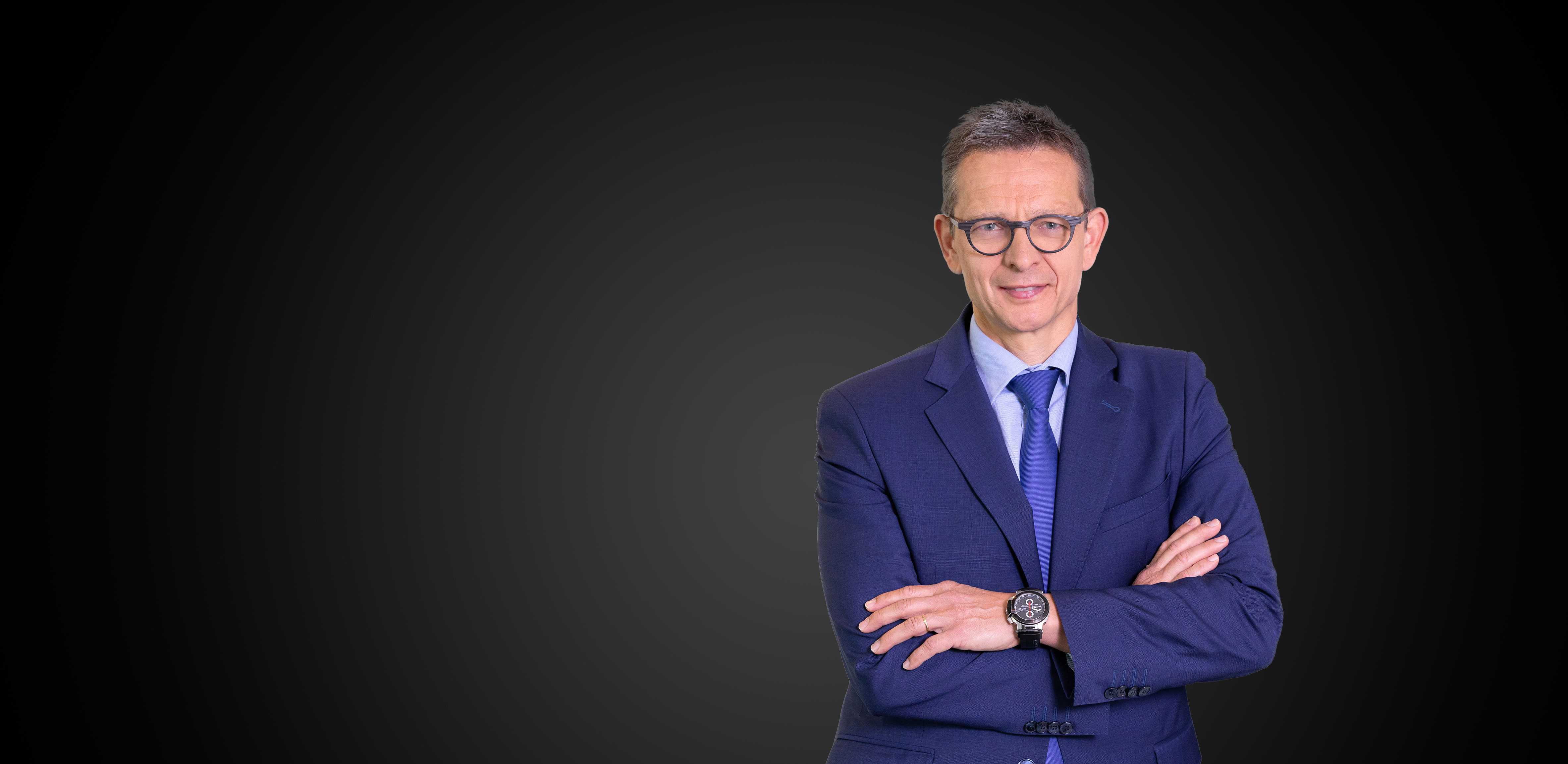 Man dressed in suits, smiling