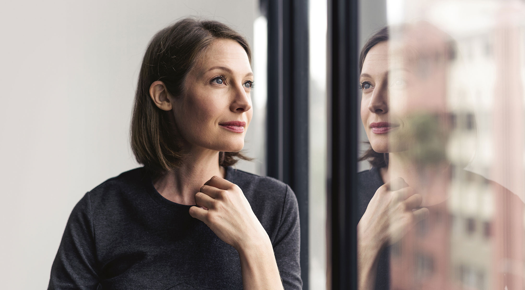 Woman looking at the windows Woman looking at the windows