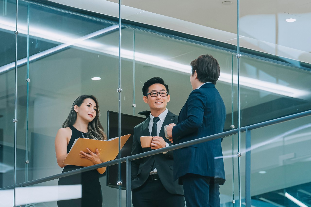 Smiling businesswoman listening during team meeting in office conference room