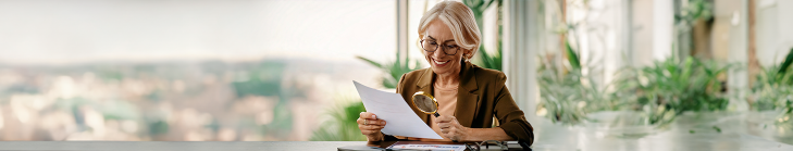 Woman reading a paper and smiling